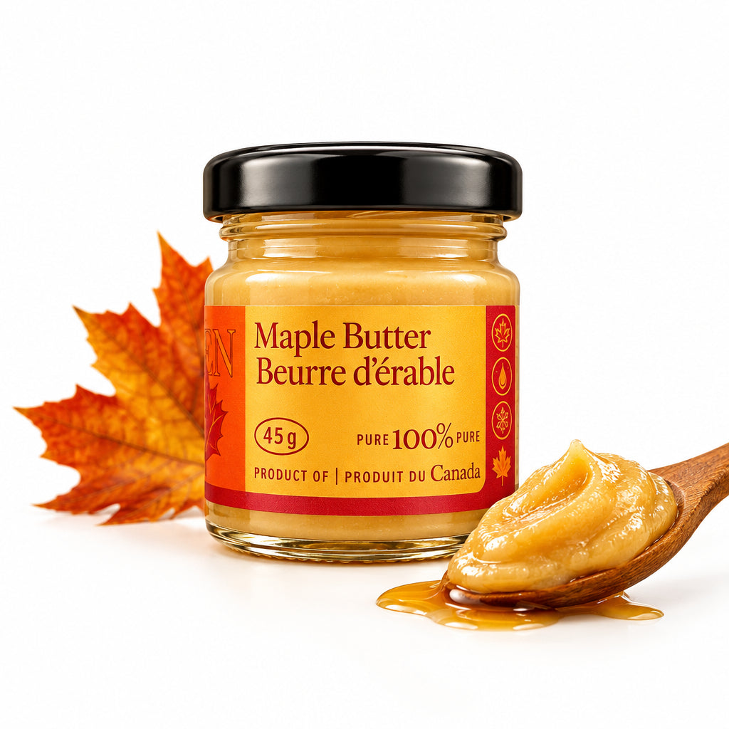 A 45g glass jar of pure maple butter with a black lid and a red and orange label, placed on a textured gray fabric background.
