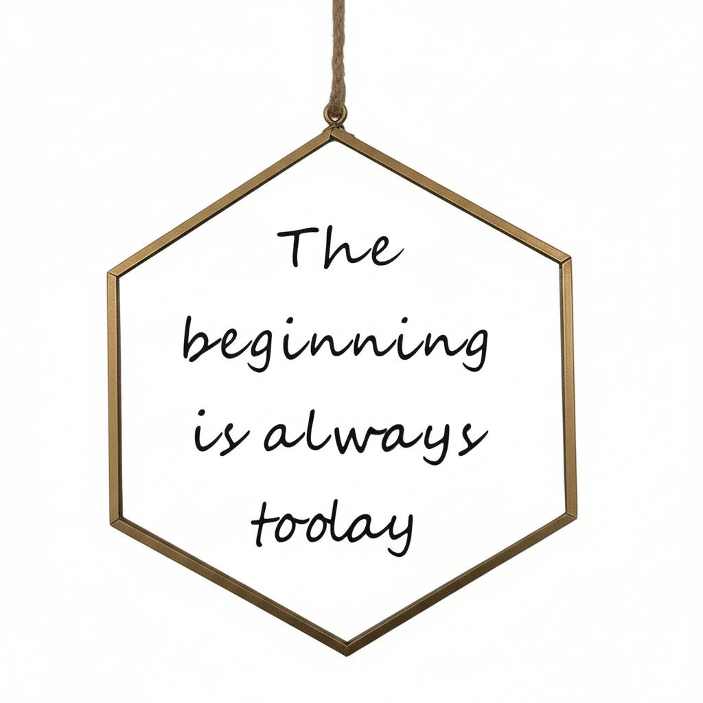 Hexagonal brass frame with 'The beginning is always today' text on a white background